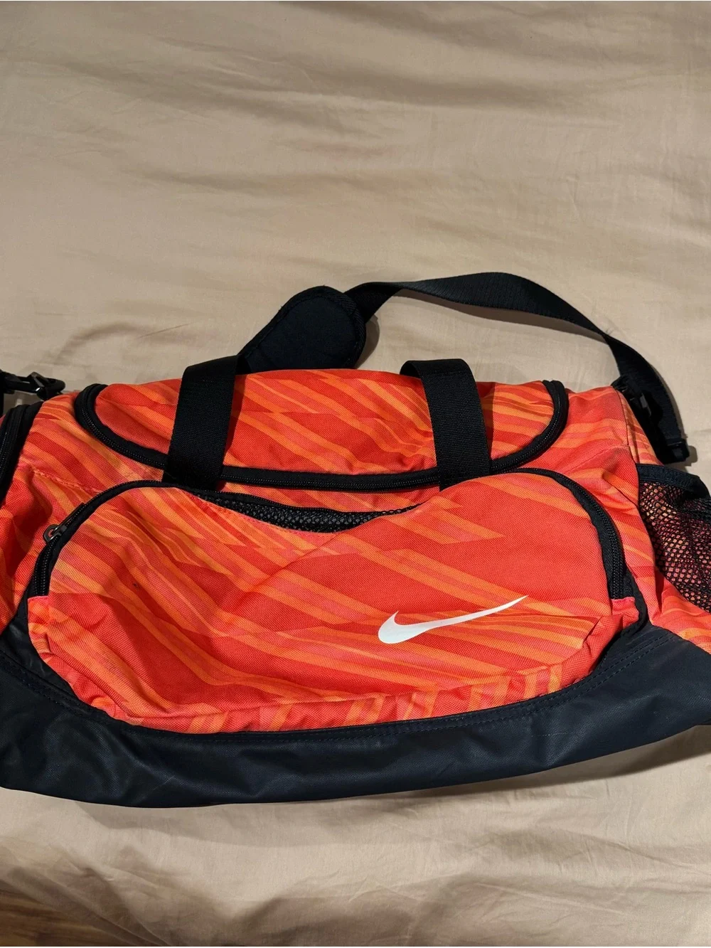 Nike Orange Striped Men's Duffel Bag with Black Accents